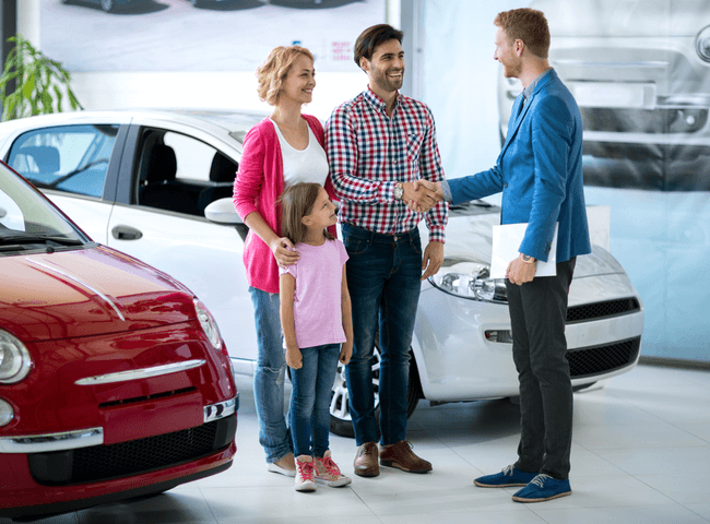 Young family purchasing car in a modern car show room